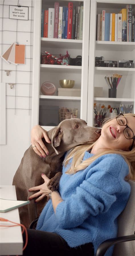 A Dog Licking and Smelling a Woman Lying Down